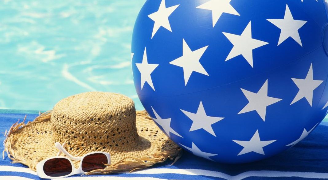 beach ball and hat by the pool