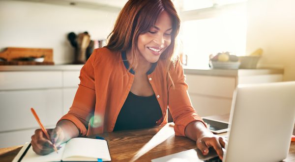 woman working on a laptop in her kitchen, Mortgage Loans baton rouge, home loans baton rouge