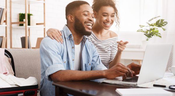 African-american couple using laptop,