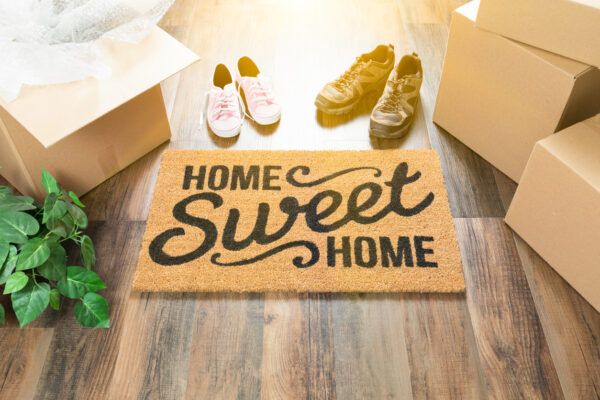 shoes with home sweet home door mat and boxes