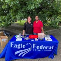 two ladies standing behind the Eagle Federal table